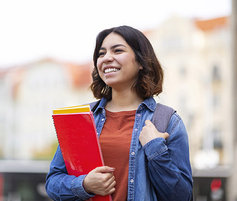 Portrait Of Happy Young Arab Student Woman Standing Outdoors